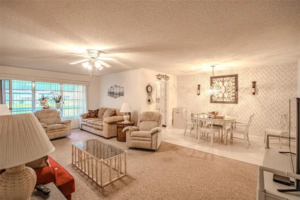 a living room with furniture dining area and a chandelier