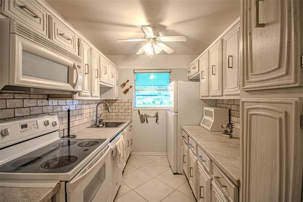 a kitchen with a sink stove and cabinets