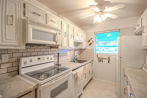 a kitchen that has a sink and a stove