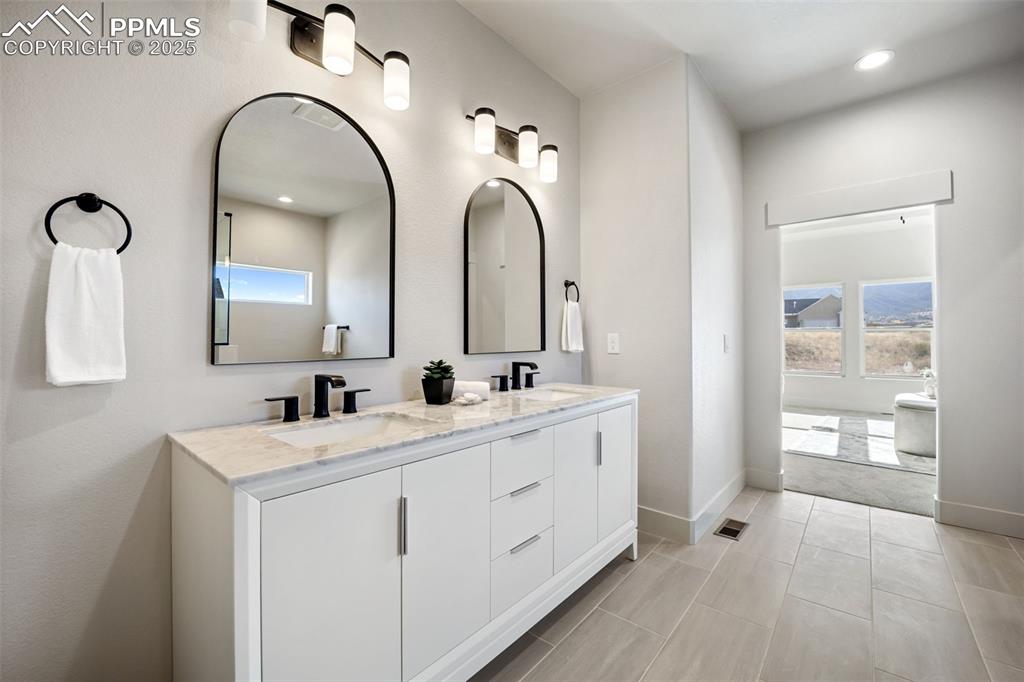 442 Gold Canyon Road Canon City, CO 81212 - Photo 18 of 38 a bathroom with a double vanity sink and a mirror