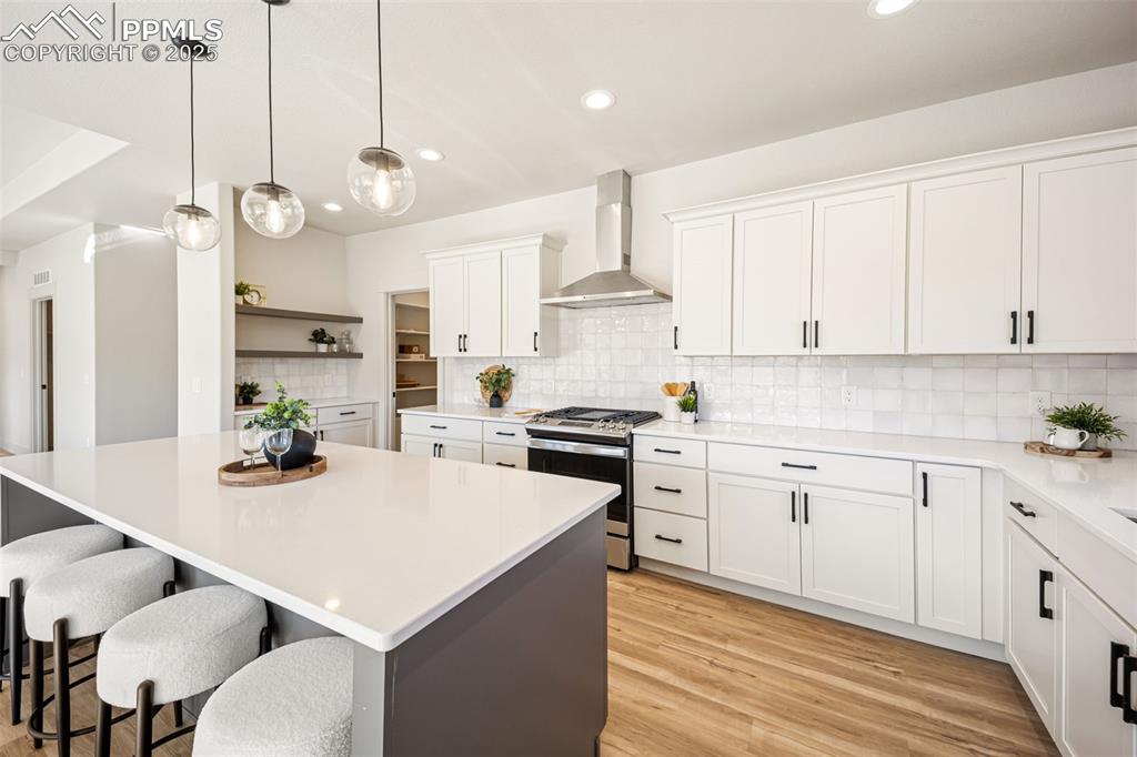 442 Gold Canyon Road Canon City, CO 81212 - Photo 2 of 38 a kitchen with stainless steel appliances kitchen island granite countertop a sink a stove a refrigerator and white cabinets