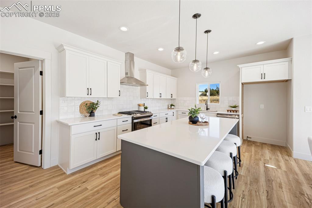 442 Gold Canyon Road Canon City, CO 81212 - Photo 4 of 38 a kitchen with white cabinets and stainless steel appliances