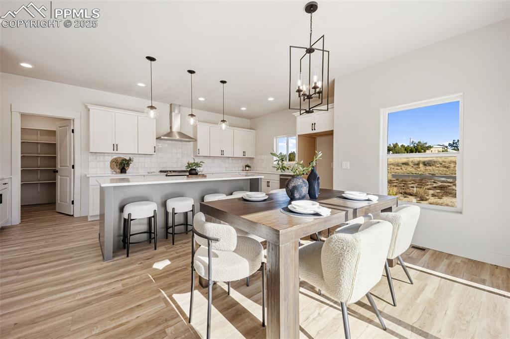 442 Gold Canyon Road Canon City, CO 81212 - Photo 8 of 38 a kitchen with stainless steel appliances kitchen island granite countertop a dining table chairs and white cabinets