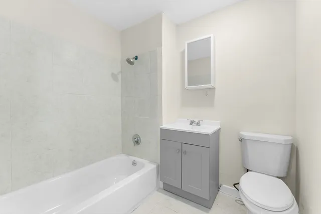 a bathroom with a toilet a sink and bathtub