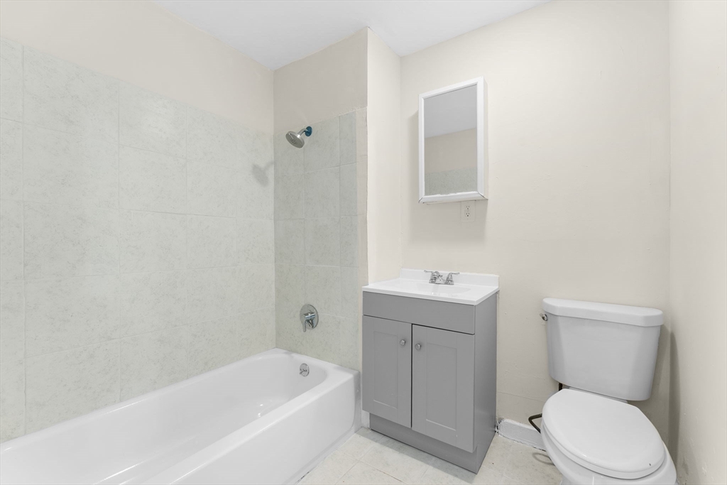 239 Bowdoin Street, Unit 3 Boston, MA 02122 - Photo 13 of 20 a bathroom with a toilet a sink and bathtub