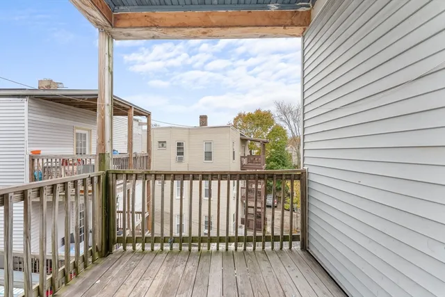 a view of a balcony with wooden floor