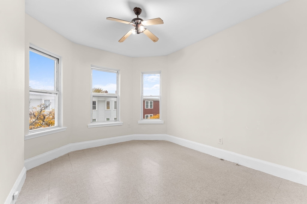 239 Bowdoin Street, Unit 3 Boston, MA 02122 - Photo 3 of 20 an empty room with windows and fan