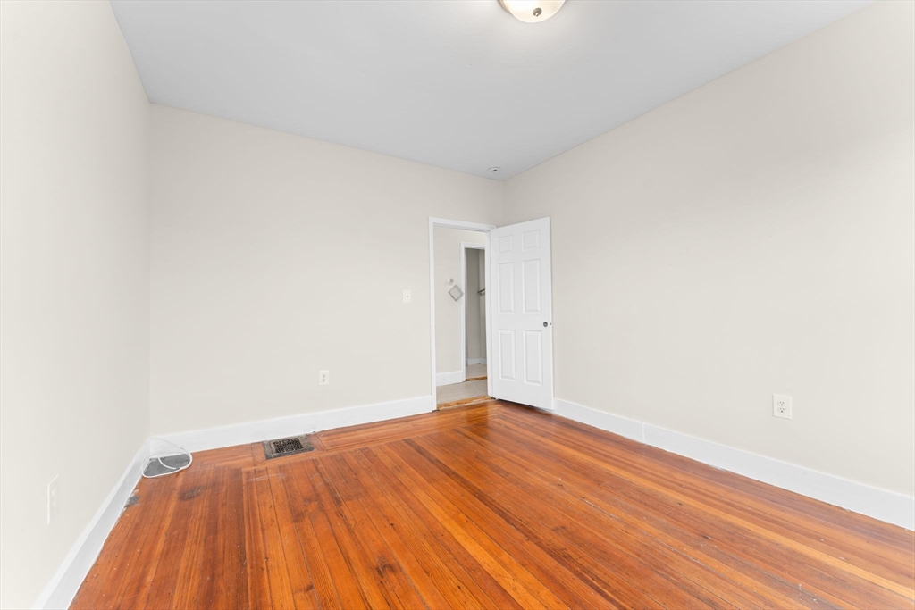 239 Bowdoin Street, Unit 3 Boston, MA 02122 - Photo 8 of 20 a view of an empty room with wooden floor