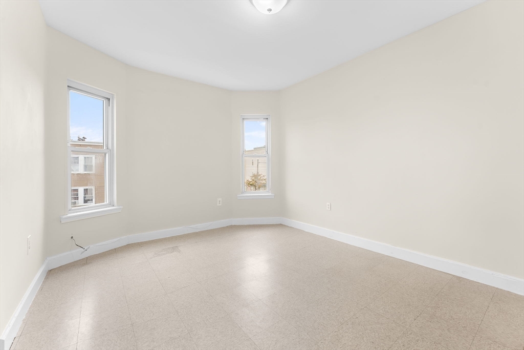 239 Bowdoin Street, Unit 3 Boston, MA 02122 - Photo 9 of 20 an empty room with windows