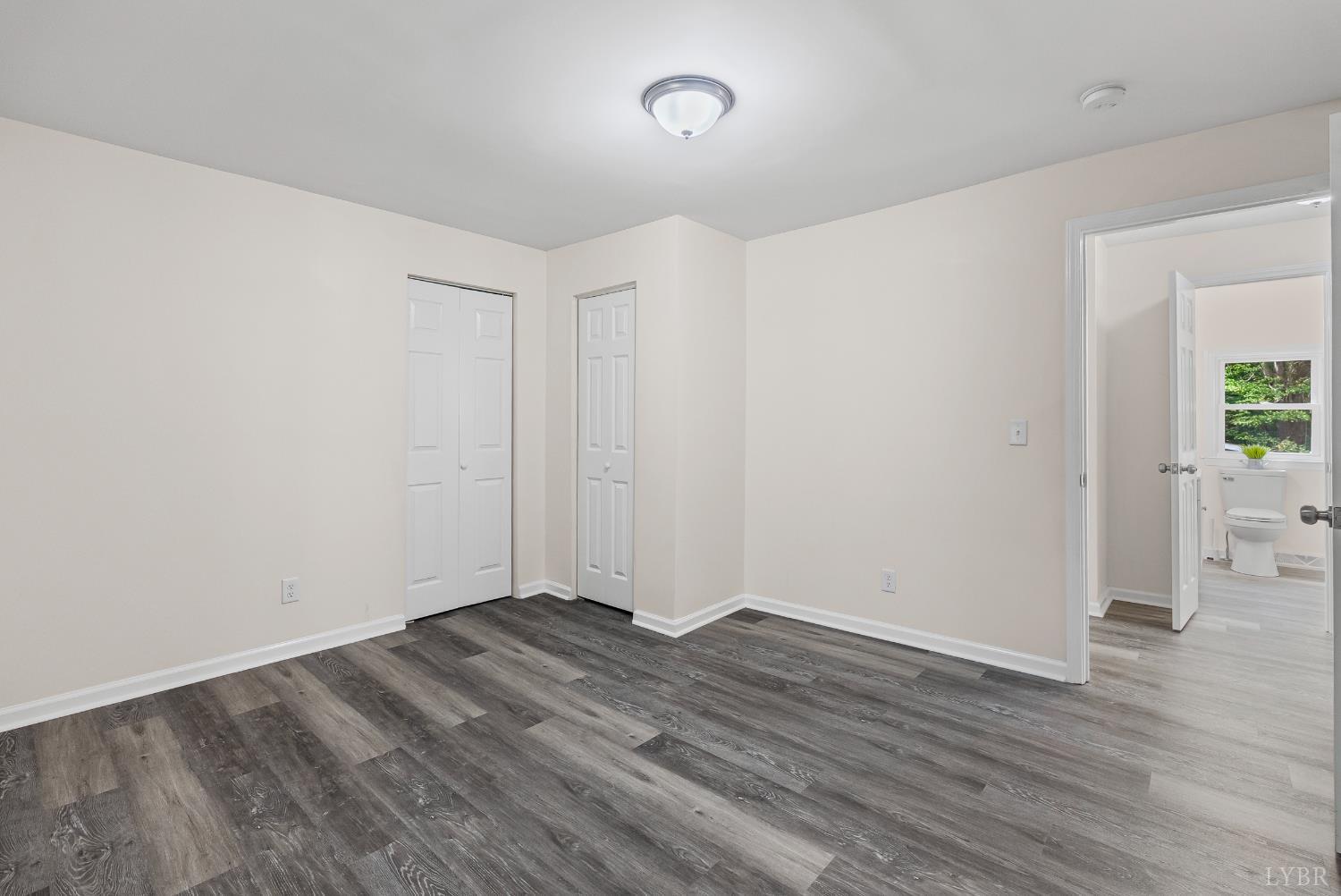 288 Moses Mill Road Chatham, VA 24531 - Photo 14 of 42 an empty room with wooden floor and windows