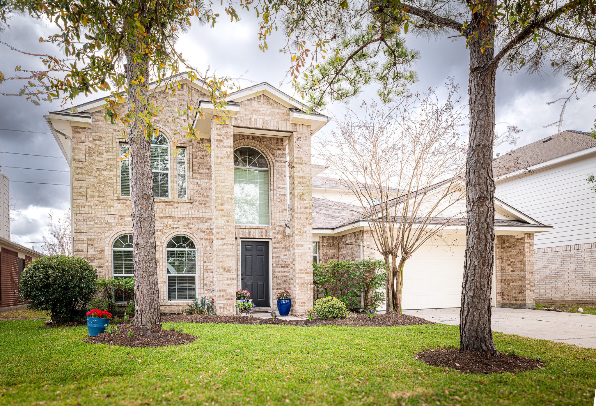 17323 Dakota Ridge Drive Houston, TX 77095 - Photo 1 of 25 a view of a white house with a yard and large tree