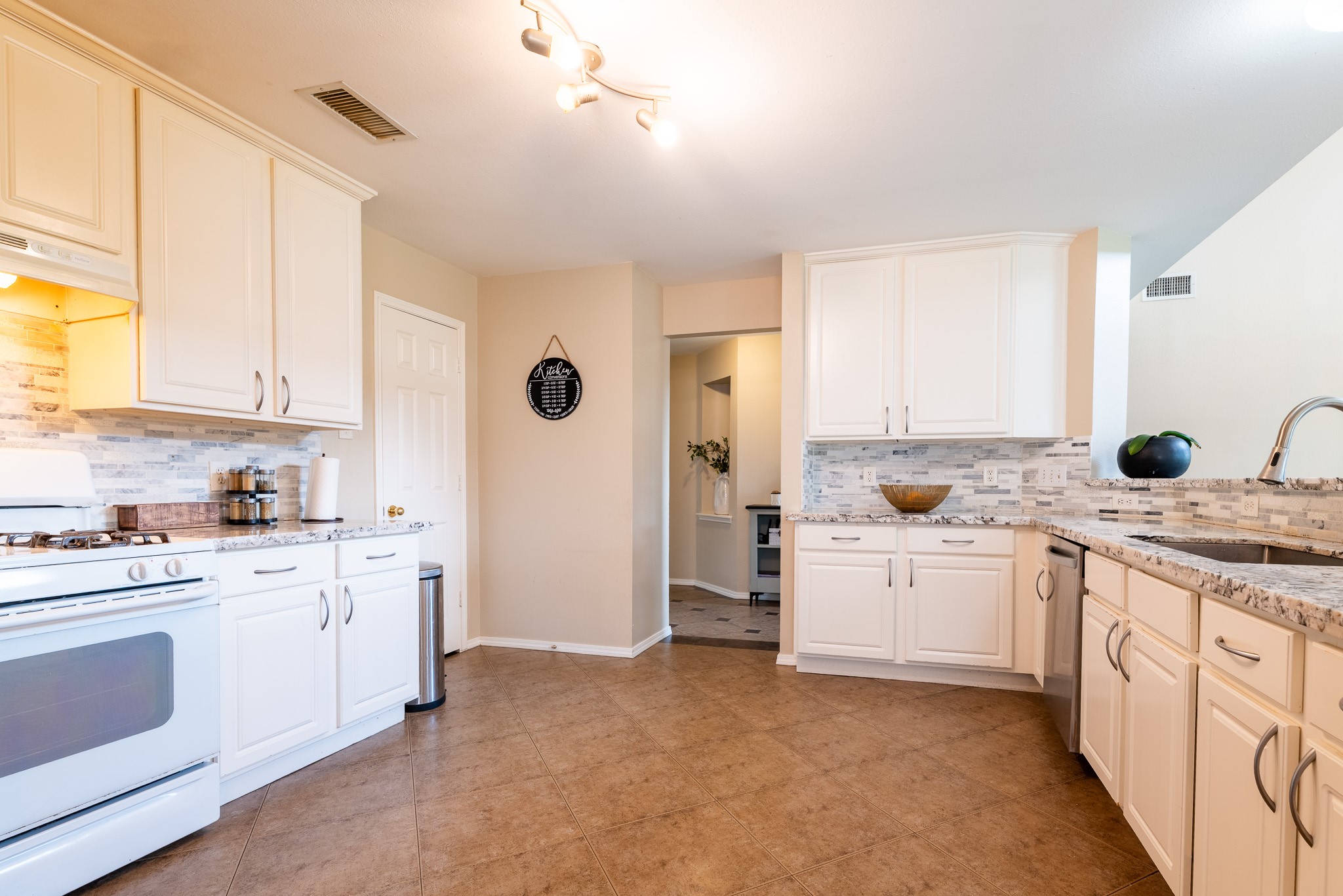 17323 Dakota Ridge Drive Houston, TX 77095 - Photo 11 of 25 a kitchen with white cabinets and white appliances