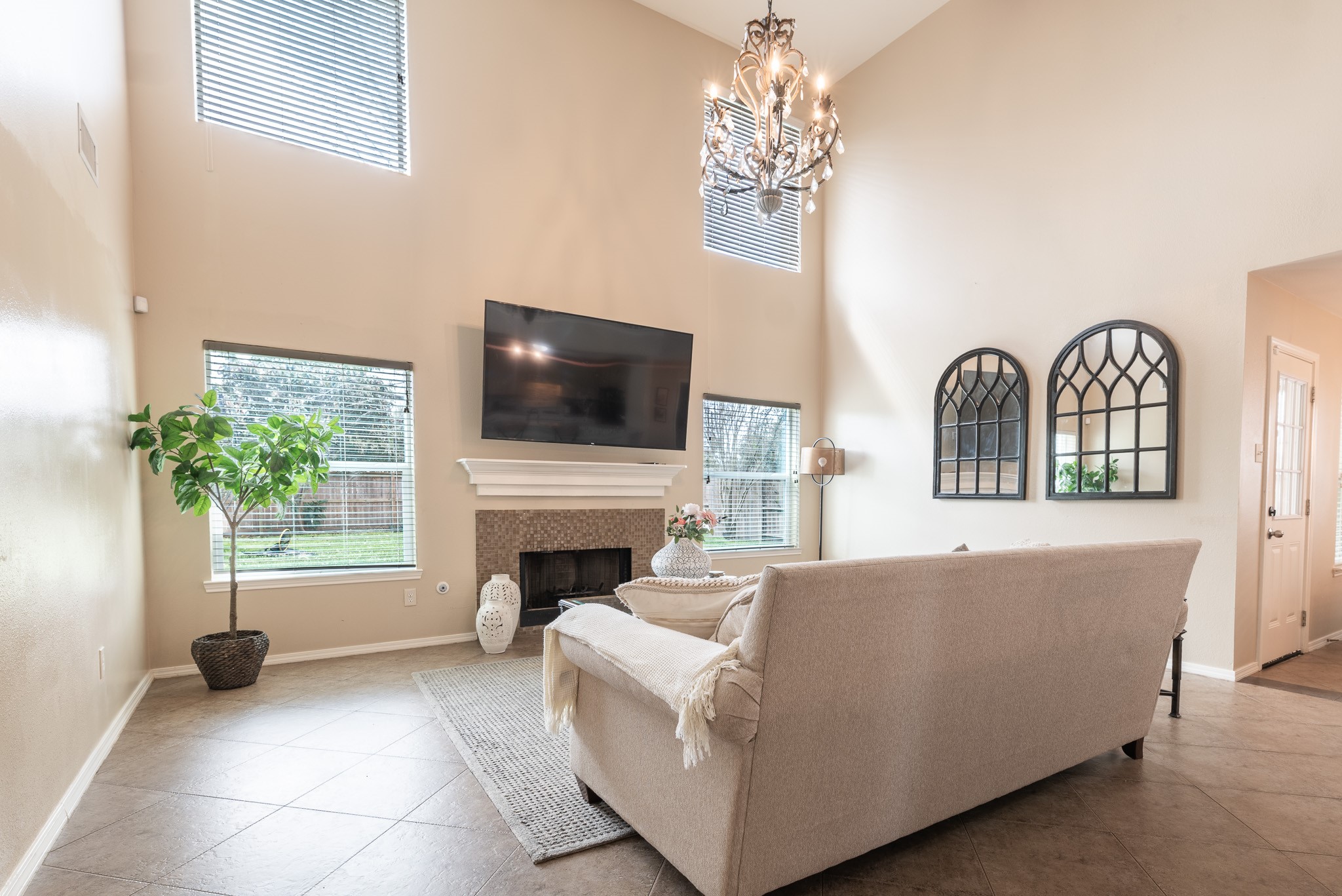17323 Dakota Ridge Drive Houston, TX 77095 - Photo 7 of 25 a living room with furniture a fireplace and a flat screen tv