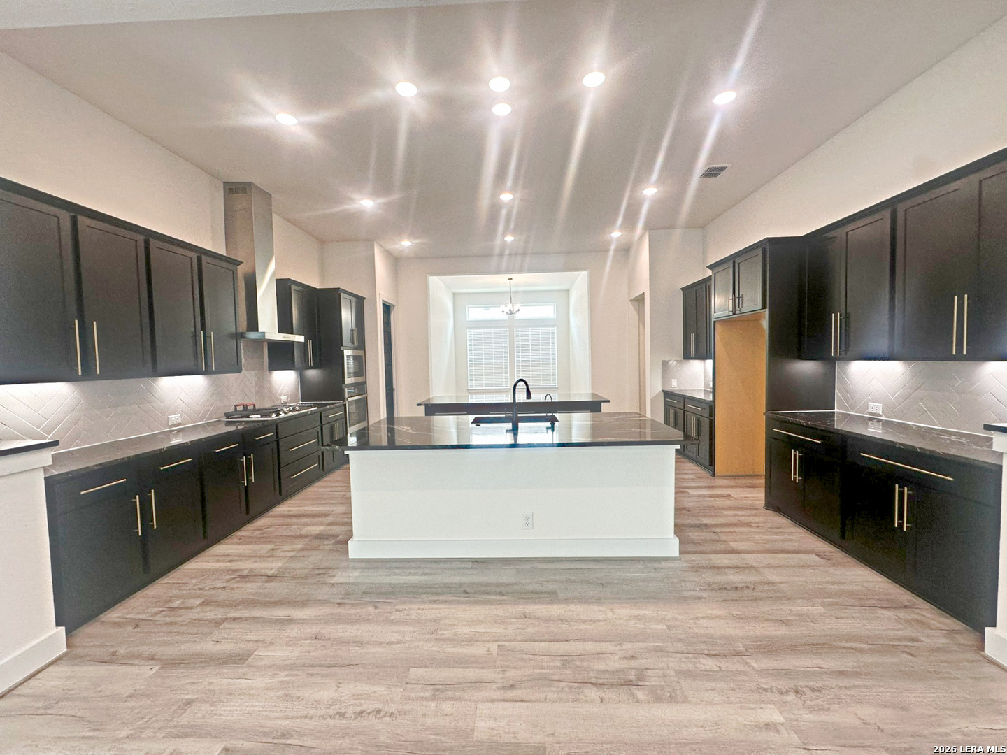 418 Corwin Springs Cibolo, TX 78108 - Photo 15 of 24 a large white kitchen with kitchen island a large counter top stainless steel appliances and cabinets