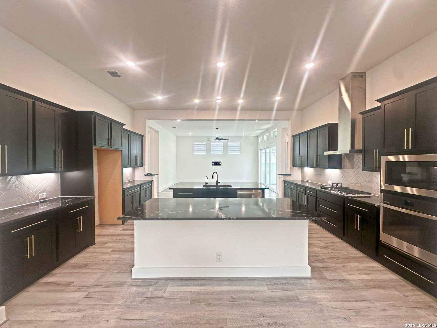 418 Corwin Springs Cibolo, TX 78108 - Photo 17 of 24 a large kitchen with stainless steel appliances kitchen island granite countertop a large counter top stainless steel appliances and cabinets