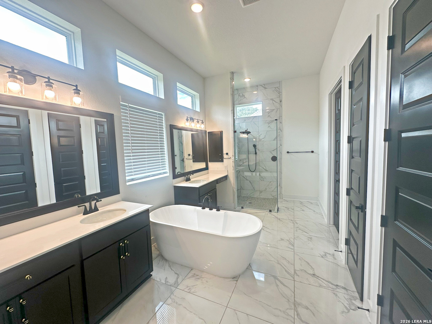 418 Corwin Springs Cibolo, TX 78108 - Photo 20 of 24 a spacious bathroom with a double vanity sink a mirror and a bathtub