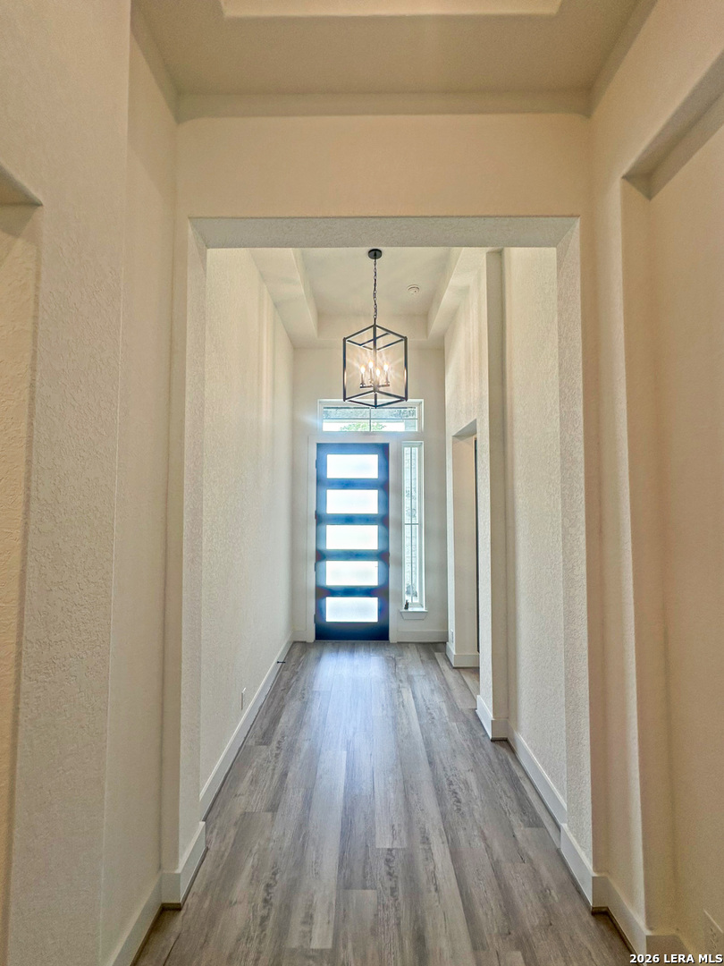 418 Corwin Springs Cibolo, TX 78108 - Photo 7 of 24 a view of a hallway with wooden floor and staircase