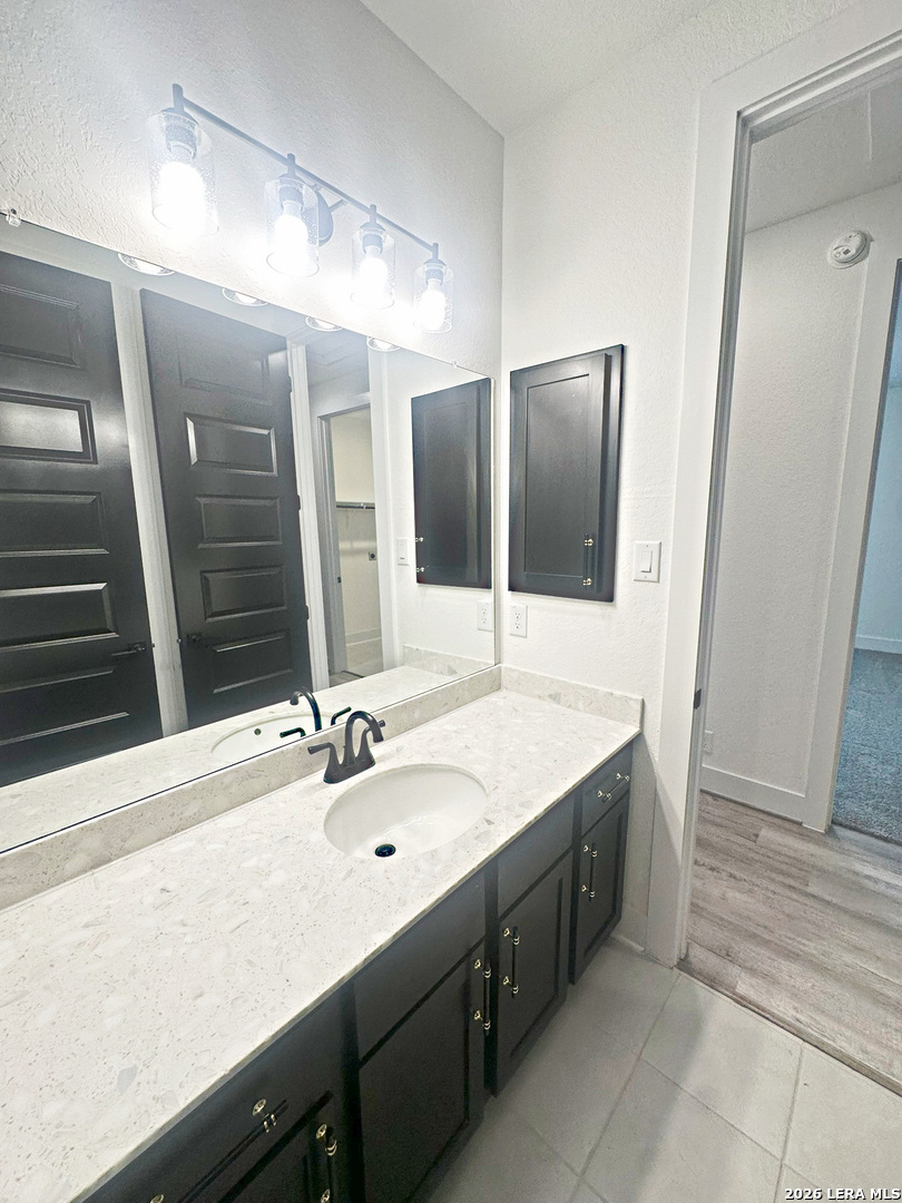 418 Corwin Springs Cibolo, TX 78108 - Photo 10 of 24 a bathroom with a double vanity sink and mirror