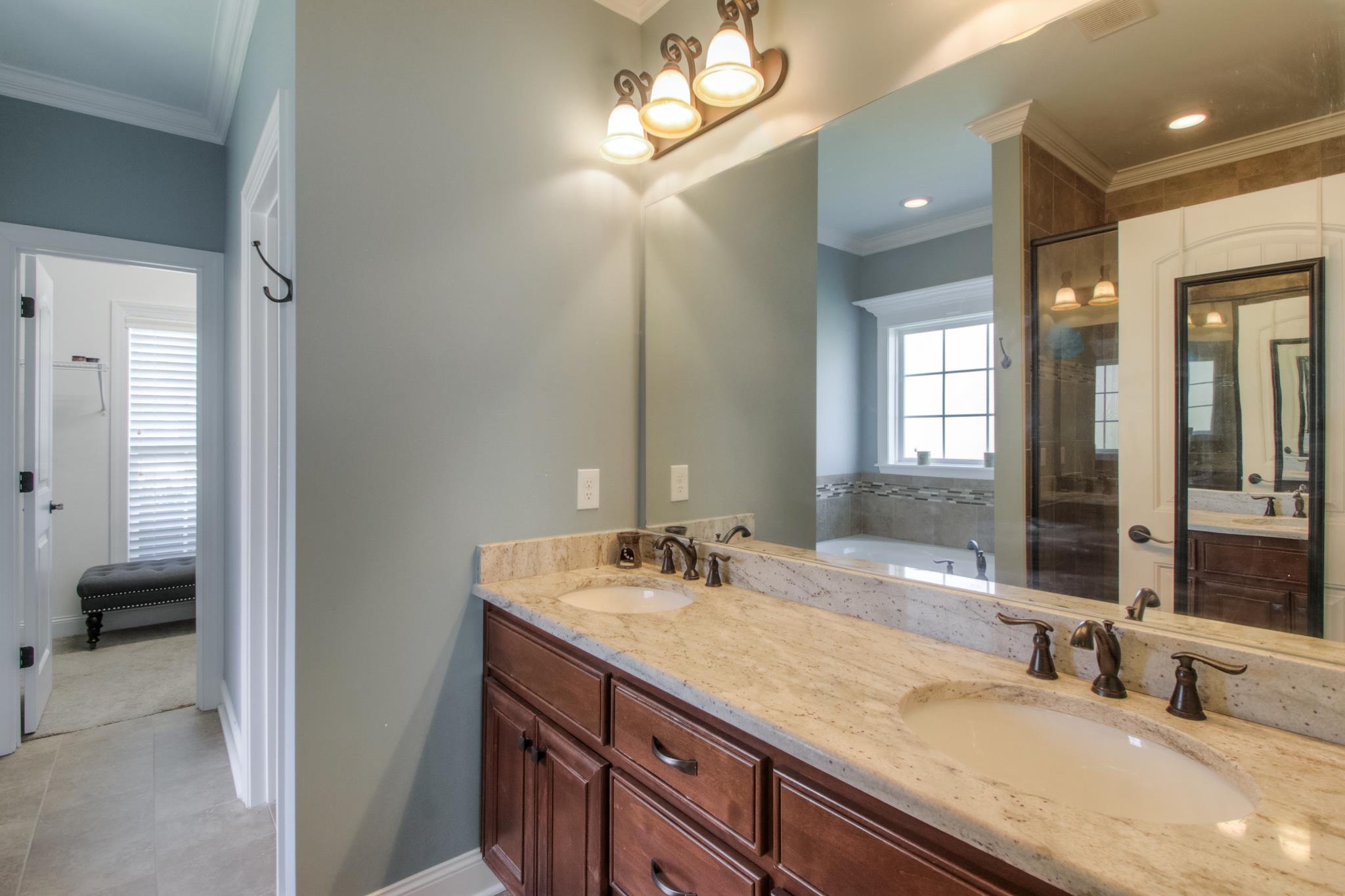 7675 Knobdate Road Smyrna, TN 37167 - Photo 16 of 26 Granite double vanity in the master bath with linen closet and a nice walk in closet.