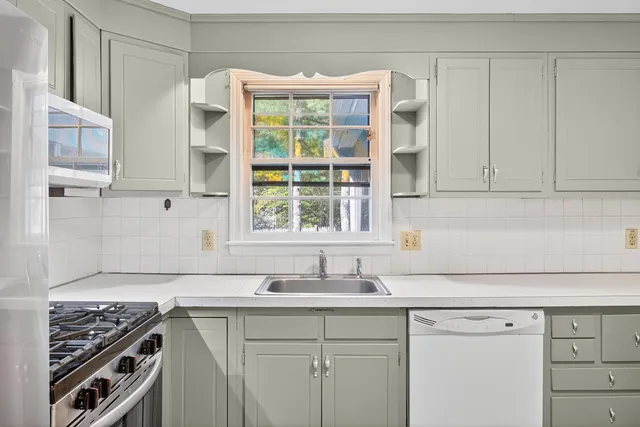 a view of a kitchen sink and a window