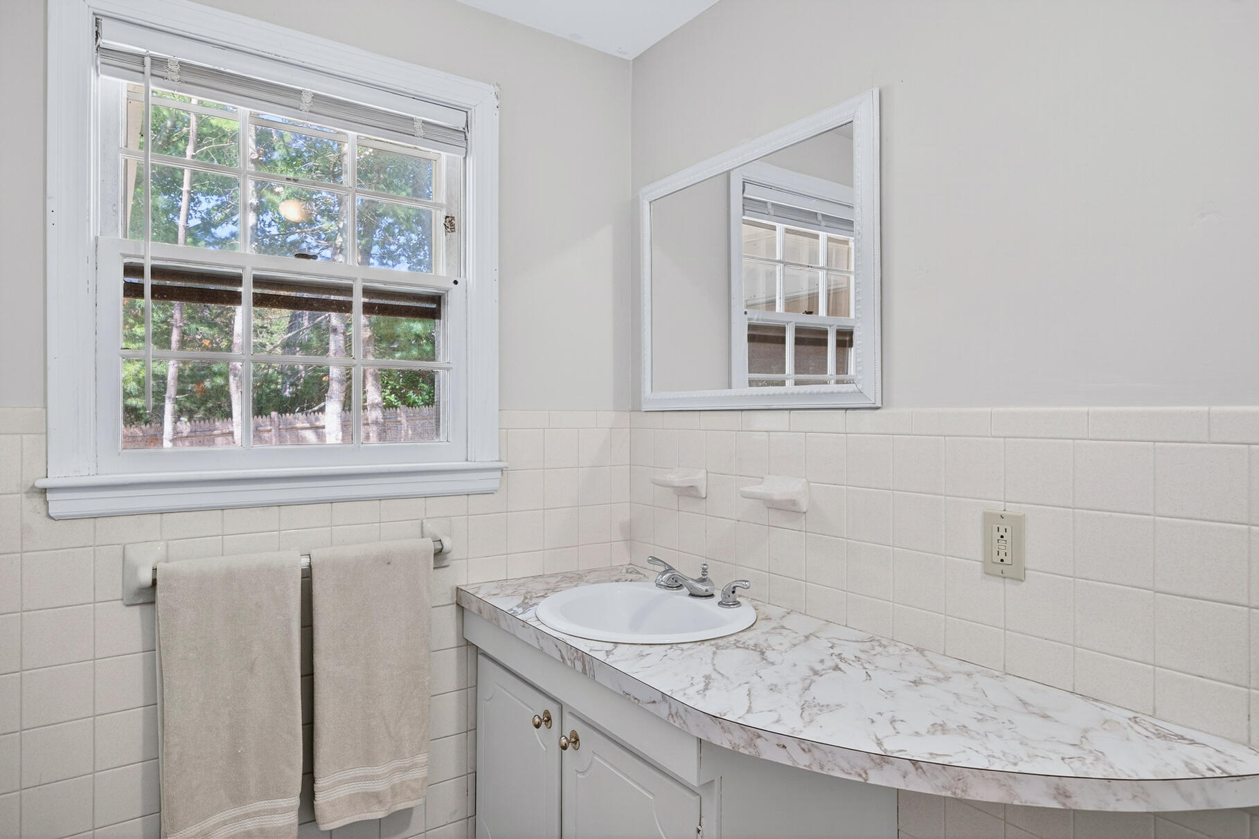101 Longfellow Drive Centerville, MA 02632 - Photo 18 of 27 a bathroom with a granite countertop sink and a window