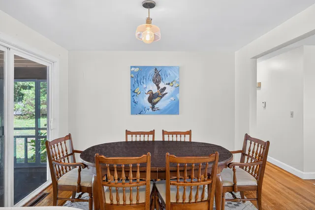a view of a dining room with furniture wooden floor and a chandelier