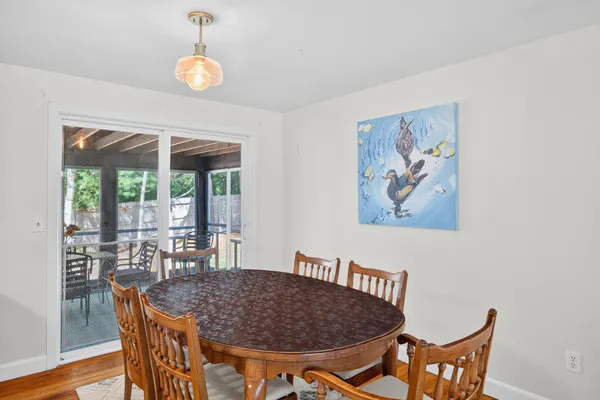 a view of a dining room with furniture wooden floor and chandelier
