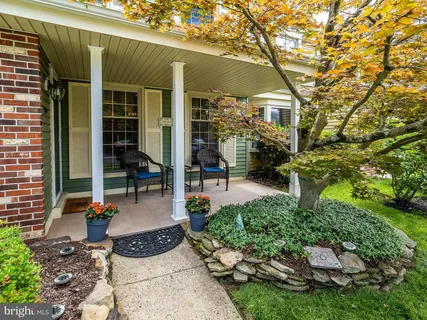 a view of a patio with table and chairs and potted plants