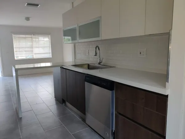 a kitchen with a sink cabinets and window