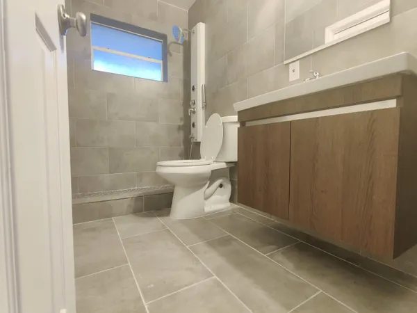 a bathroom with a toilet and a shower