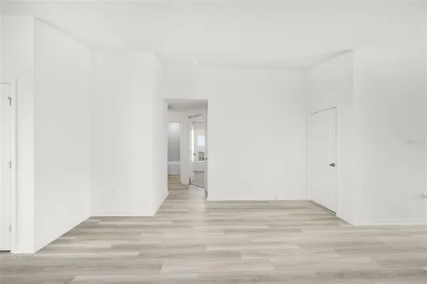 a view of an empty room and wooden floor