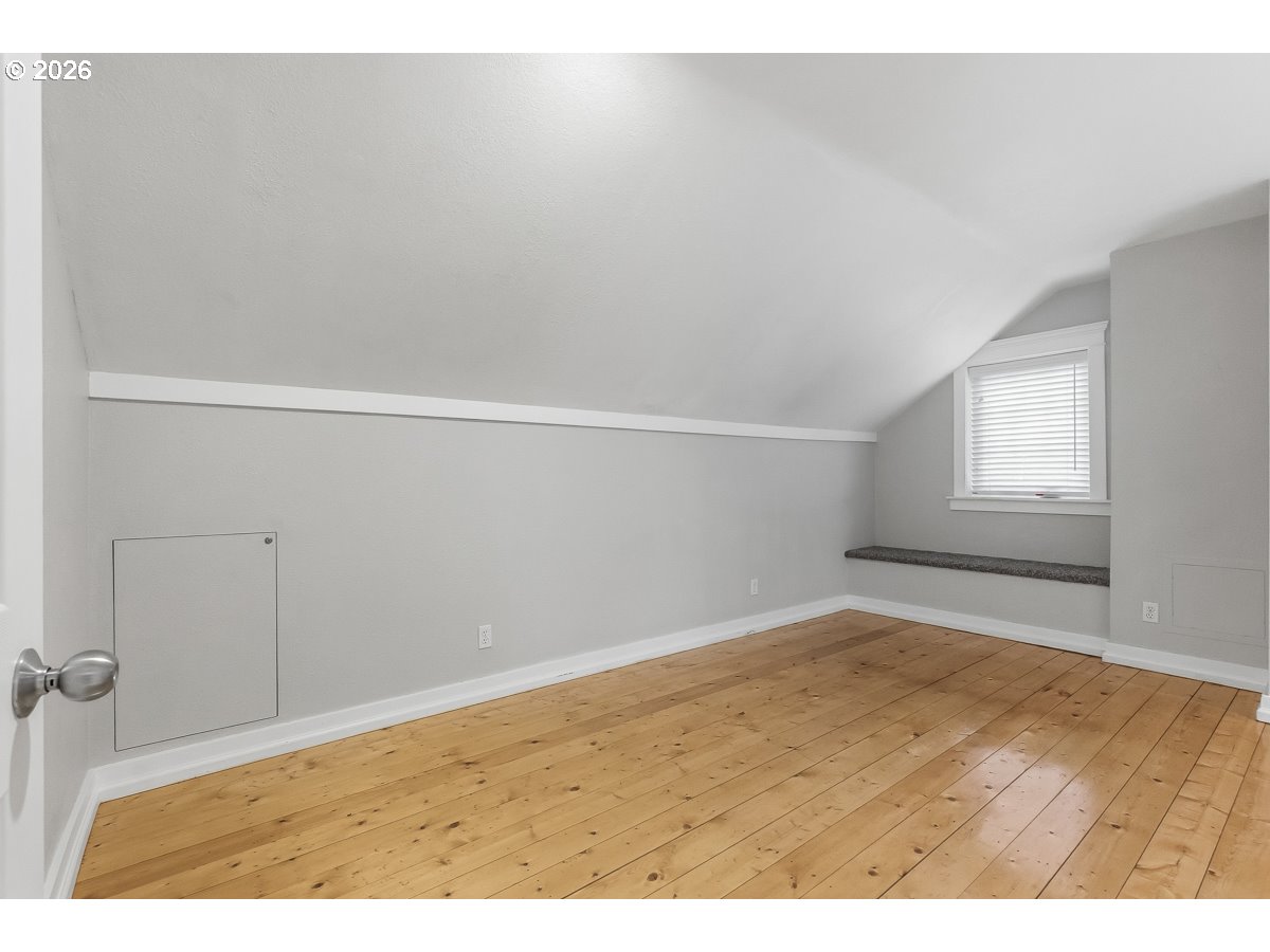 16042 Southwest Waxwing Way Beaverton, OR 97007 - Photo 37 of 48 an empty room with wooden floor and windows