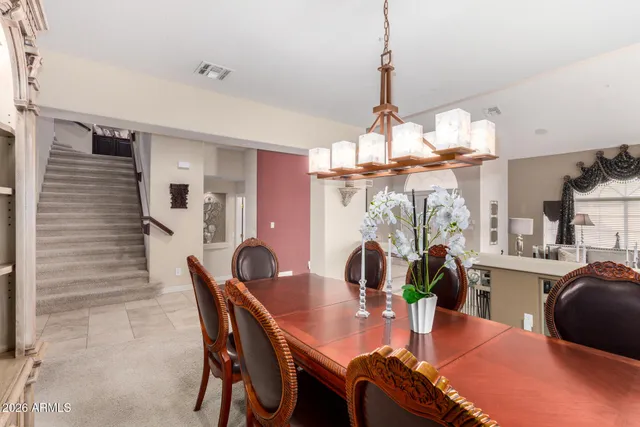 a view of a dining room with furniture and a chandelier fan