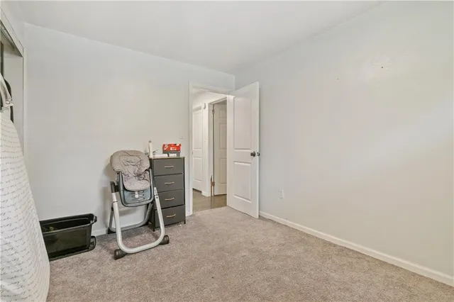 a large bed sitting in a bedroom and a table