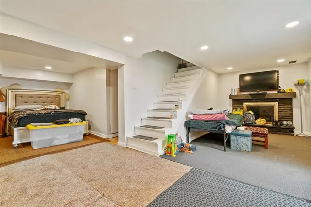 a living room with furniture gym equipment and a rug