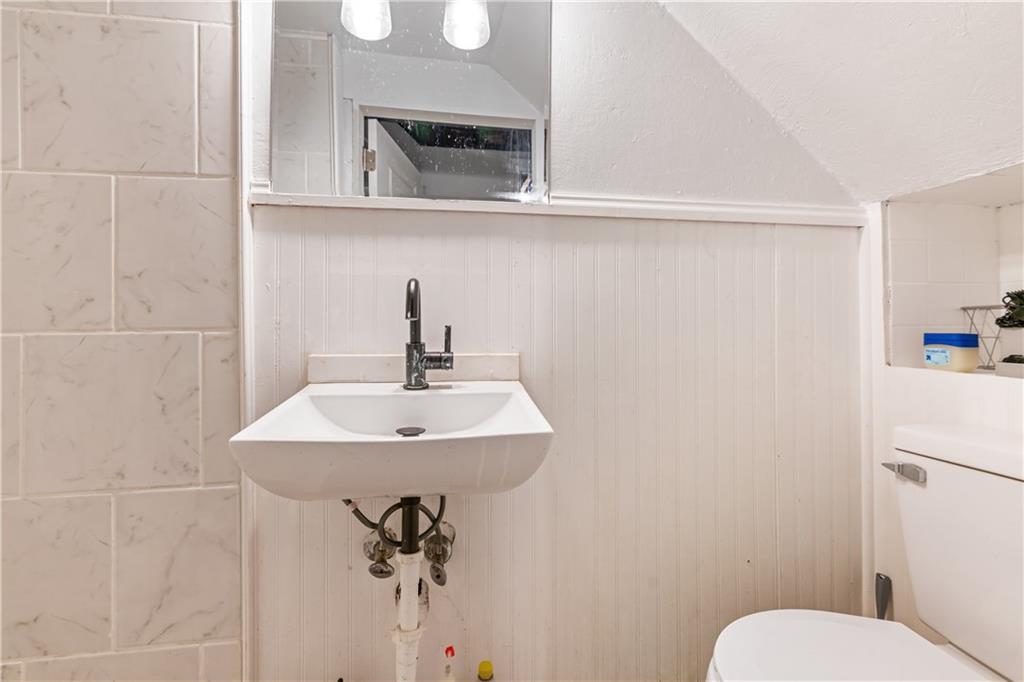 2429 Perry Street Munhall, PA 15120 - Photo 19 of 23 a bathroom with a sink mirror and toilet