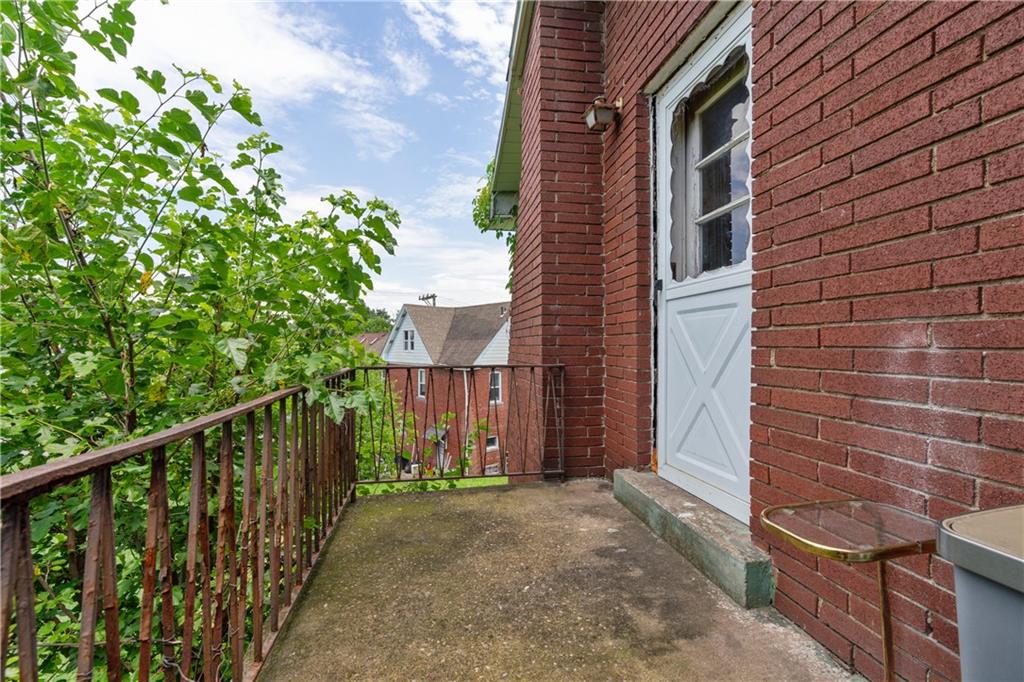 2429 Perry Street Munhall, PA 15120 - Photo 21 of 23 a view of a brick house with a small yard