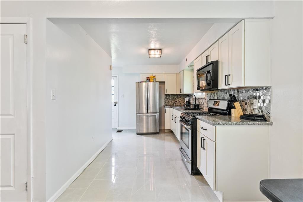 2429 Perry Street Munhall, PA 15120 - Photo 6 of 23 a kitchen with stainless steel appliances a refrigerator a stove top oven a sink and dishwasher