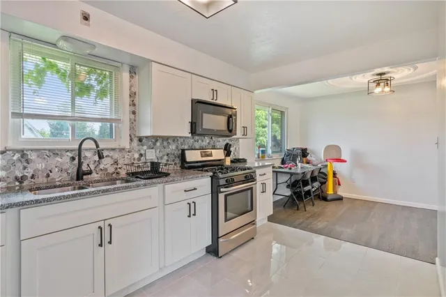 a kitchen with a sink cabinets and a window