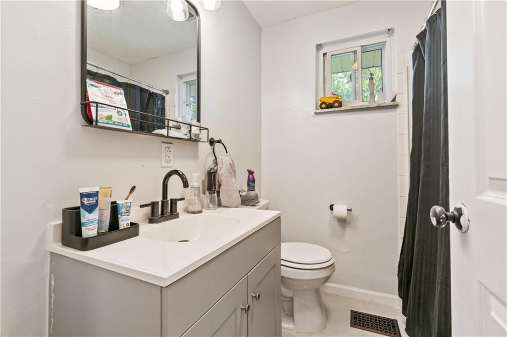 2429 Perry Street Munhall, PA 15120 - Photo 10 of 23 a bathroom with a toilet sink and mirror