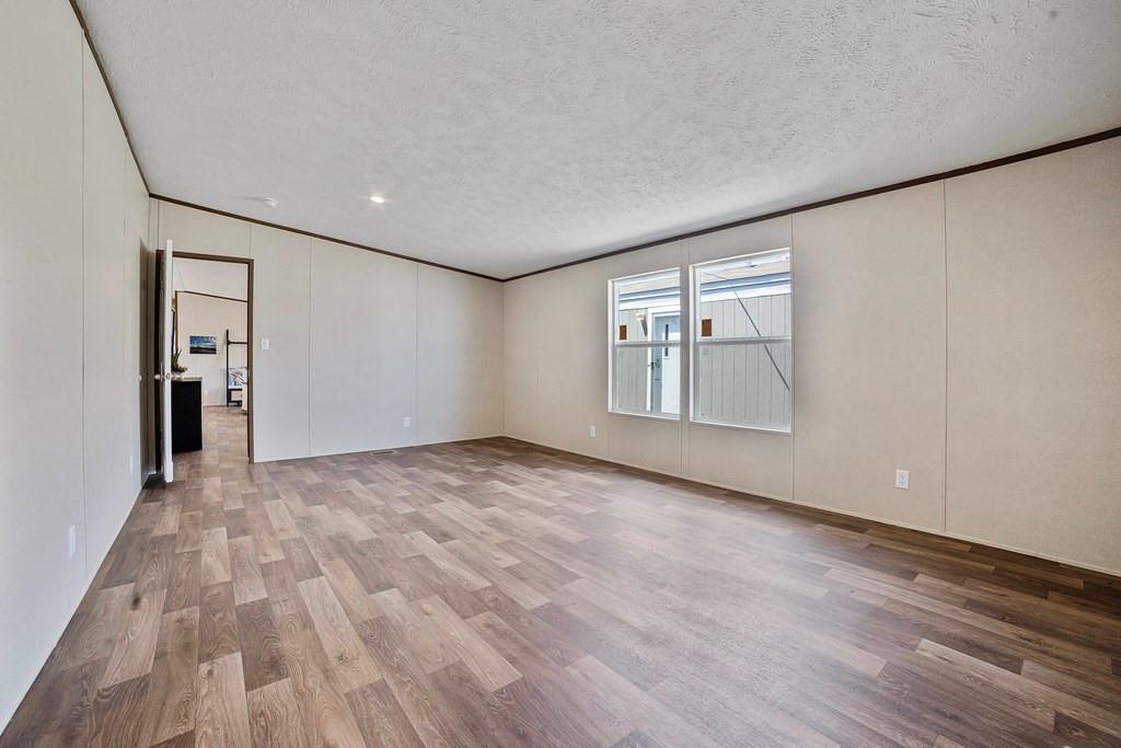 284 Pine Grove Road Gordonville, TX 76245 - Photo 19 of 29 a view of empty room with wooden floor and fan