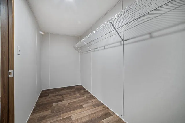 a view of a room with wooden floor