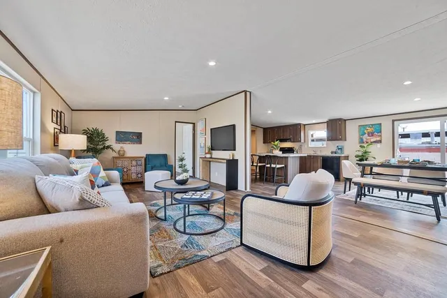 a living room with furniture and wooden floor