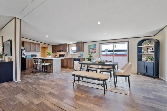 a living room with furniture and kitchen view