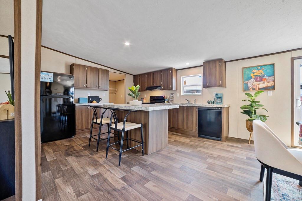 284 Pine Grove Road Gordonville, TX 76245 - Photo 10 of 29 a kitchen with a table chairs refrigerator and a counter top space