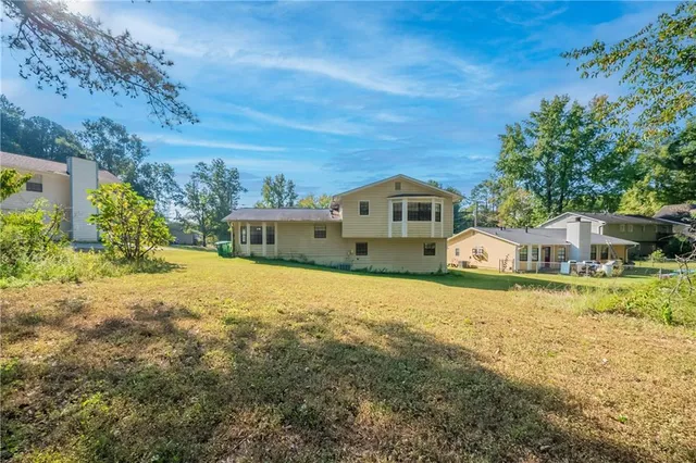 a view of yard with large trees