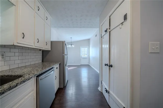 a kitchen with a refrigerator and a sink