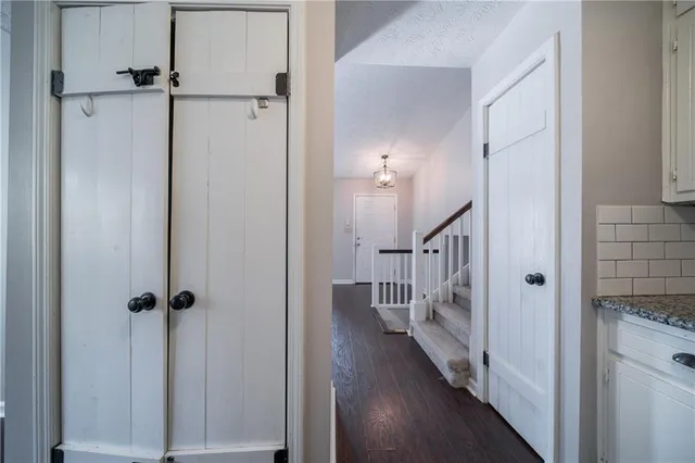 a view of a hallway with wooden floor and staircase