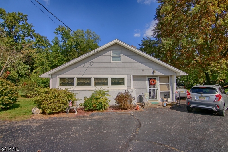 96 Parsippany Road Whippany, NJ 07981 - Photo 5 of 12 a front view of a house with a garden