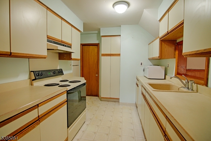 96 Parsippany Road Whippany, NJ 07981 - Photo 10 of 12 a kitchen with stainless steel appliances granite countertop a stove and a refrigerator